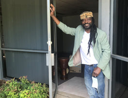 Mady Keita outside new African drum shop in Bayswater