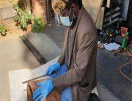 Mady Keita making djembe drum with Covid mask